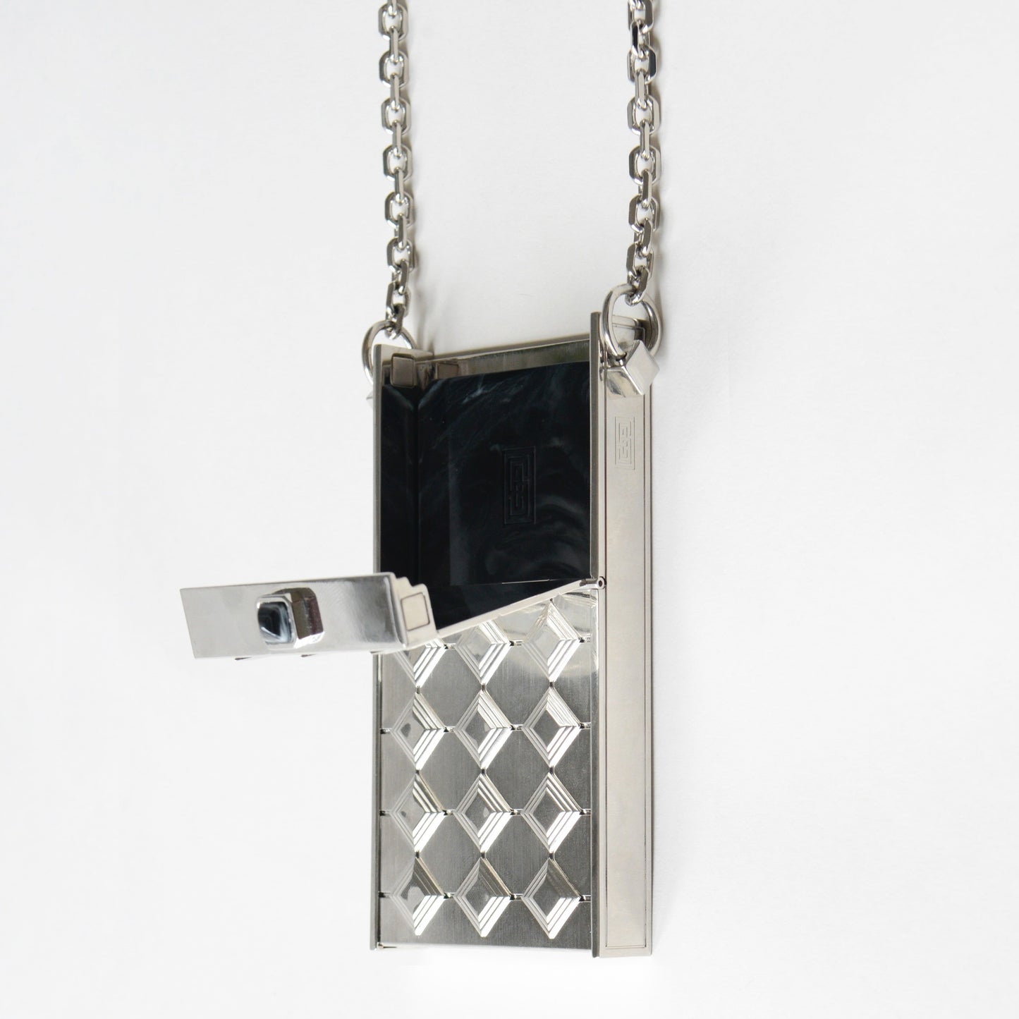 Open silver cigarette case pendant with removable cigarette insert.